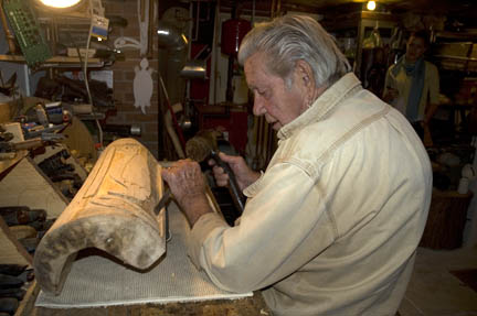 Cayoni working on an eagle mask. Photo by Maggie Holtzberg.
